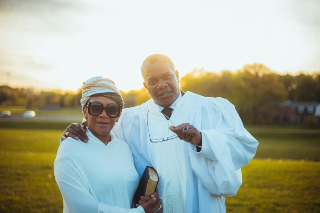image of two people in white robes in front of a sunset